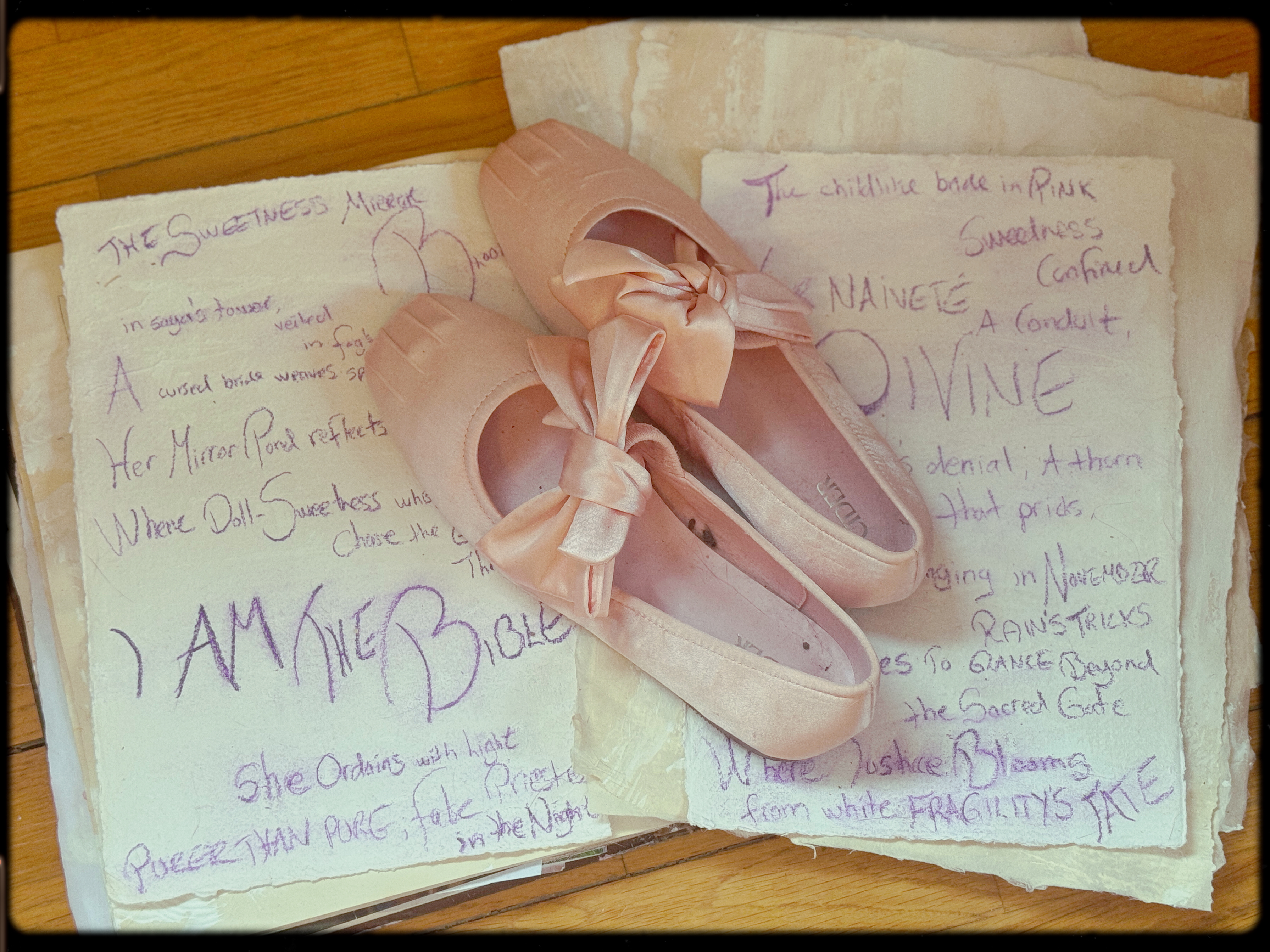 Ballet shoes on handwritten poetry